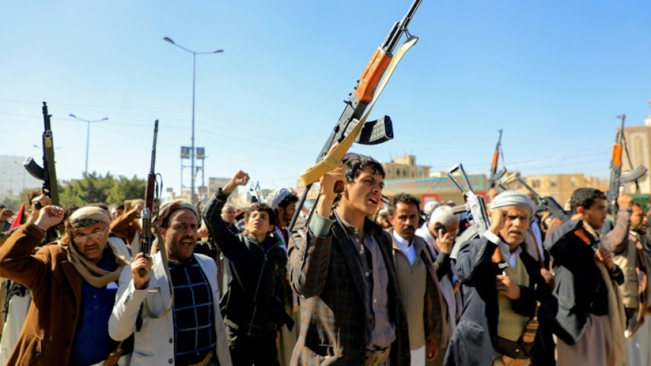 Huthi fighters brandish weapons during a march in solidarity with the Palestinian people in Yemen's Huthi-controlled capital Sanaa on Thursday