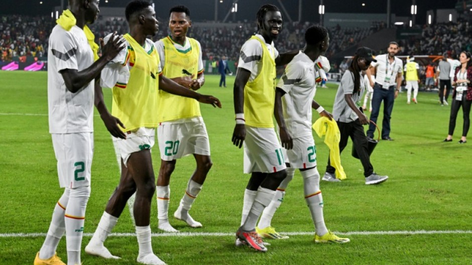 Senegal players celebrate after beating Guinea 2-0 in Yamoussoukro