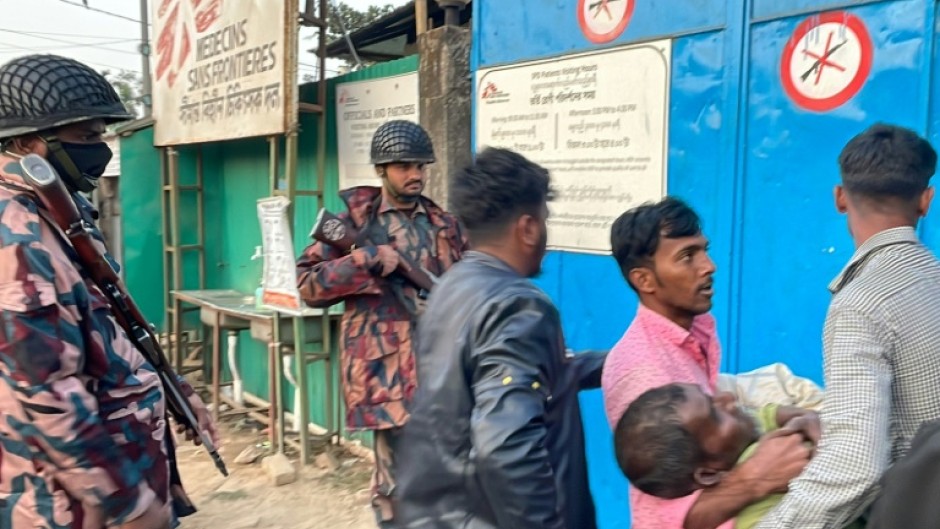 A man with bullet wounds is carried into a Doctors Without Borders hospital in Bangladesh after fighting just across the frontier with Myanmar 
