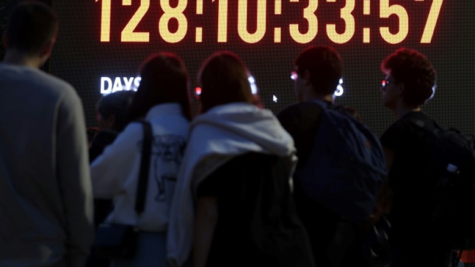 Relatives and supporters of Israeli hostages held in Gaza look at a screen showing showing the days, hours, minutes and seconds since the October 7 attack