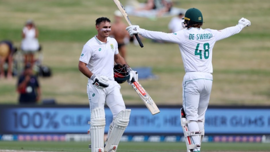 South Africa's David Bedingham (left) is congratulated after reaching his hundred by Ruan de Swardt