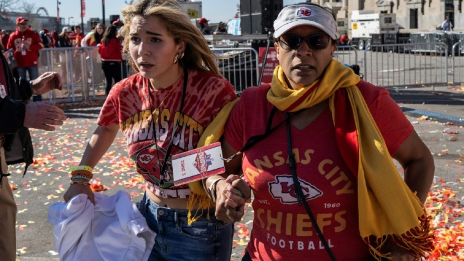 People flee after shots were fired near the Kansas City Chiefs' Super Bowl LVIII victory parade on February 14, 2024, in Kansas City, Missouri