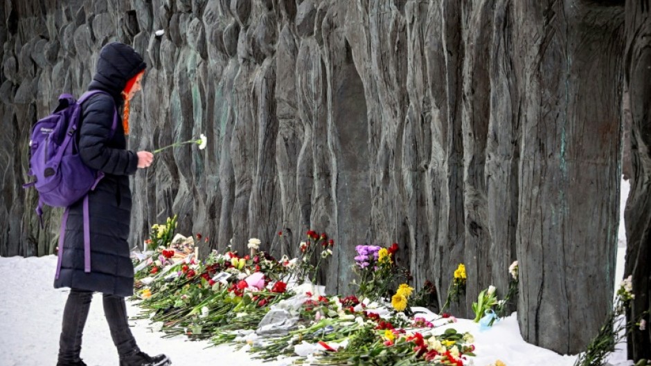 Some mourners gathered at a monument to victims of Soviet-era repression known as the 'Wall of Grief'