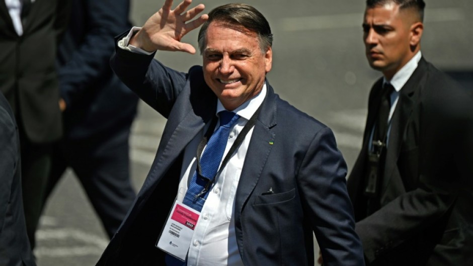 Brazilian ex-president Jair Bolsonaro, seen in December 2023, is accused of leading a plot to falsely discredit the election system and prevent President Luiz Inacio Lula da Silva from taking power