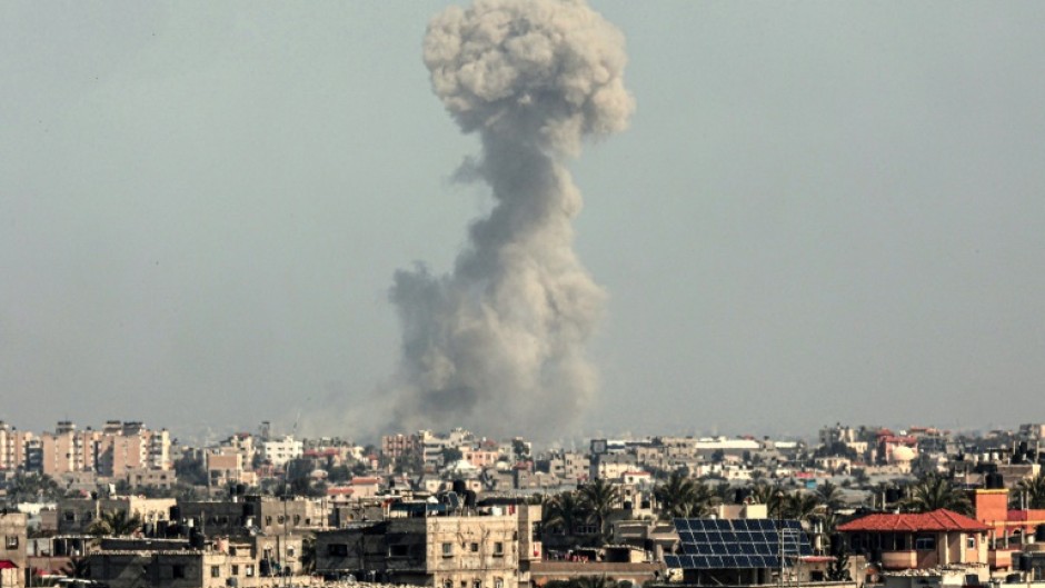 Smoke billows over Khan Yunis in the southern Gaza Strip during Israeli bombardment on February 21, 2024