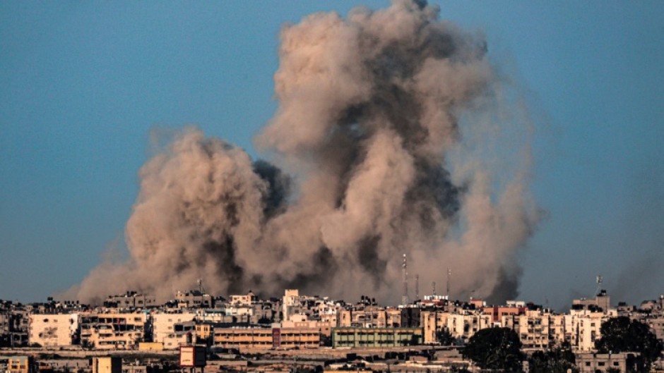 This picture taken from Rafah in the southern Gaza Strip shows smoke billowing during Israeli bombardment on Khan Yunis on February 22, 2024
