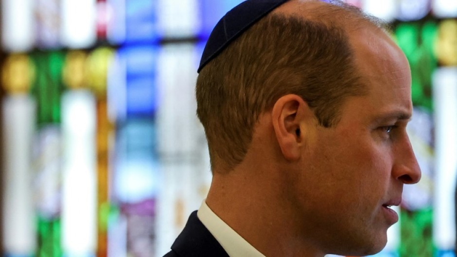 Prince William wears a kippah during a visit to the Western Marble Arch Synagoguein London
