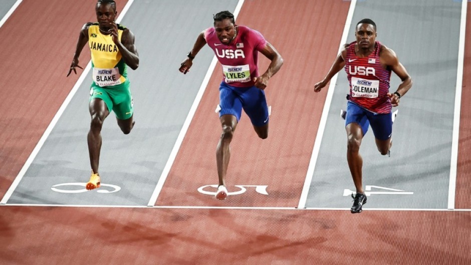 Jamaica's Ackeem Blake (L), Noah Lyles (C) and Christian Coleman (R) cross the finish line of the 60m