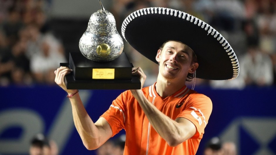 Australia's Alex de Minaur celebrates with his trophy after winning the ATP Mexico Open final over Norway's Casper Ruud