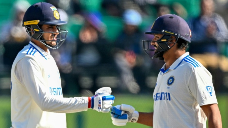 India's captain Rohit Sharma (R) fist bumps Shubman Gill during the second day of the fifth Test against England 