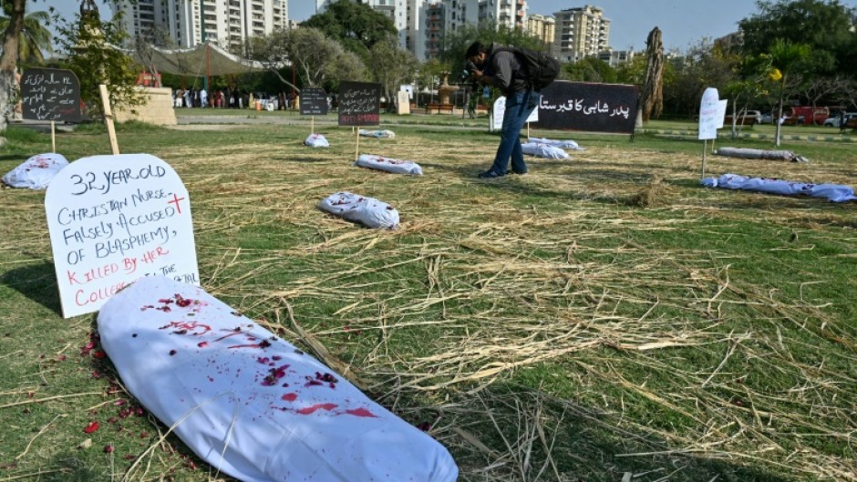 Paint-spattered bodybags represent the toll of violence against women in Karachi, Pakistan