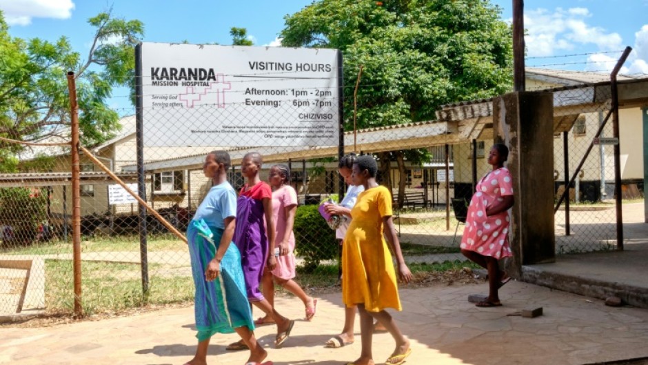 Pregnant women take a walk outside the maternity ward at Karanda Mission Hospital in Zimbabwe's Mount Darwin