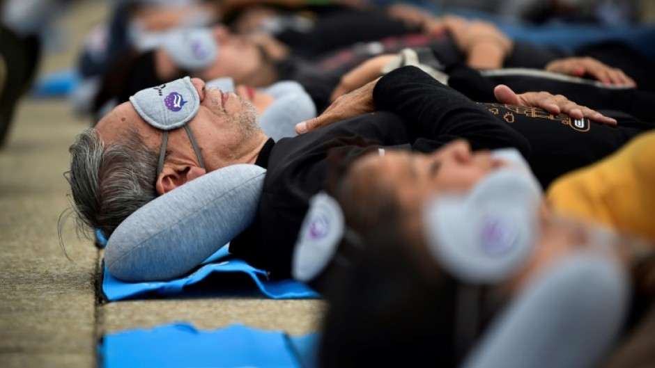 Around 200 people take part in a collective siesta in Mexico City to mark World Sleep Day