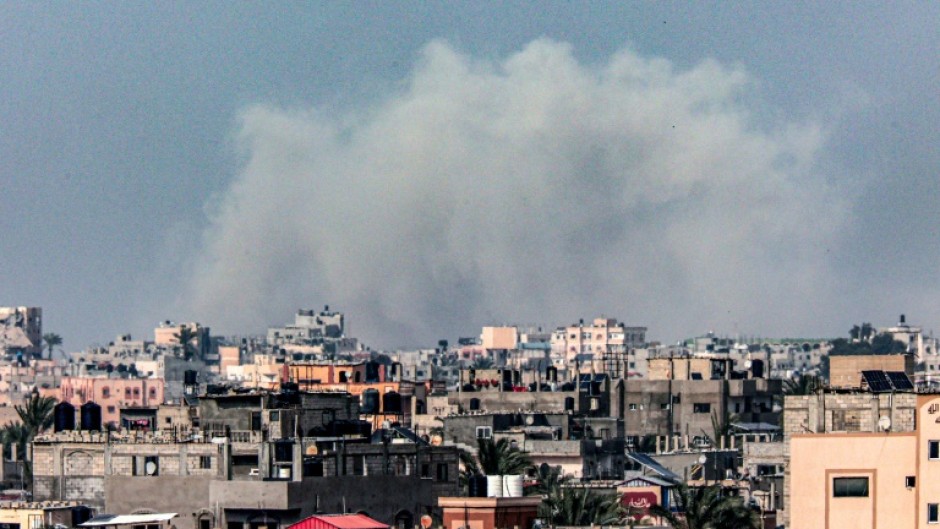 A picture taken from Rafah shows smoke billowing over Khan Yunis in the southern Gaza Strip during Israeli bombardment 