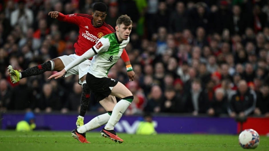 Manchester United substitute Amad Diallo (L) scores the winning goal against Liverpool in an FA Cup quarter-final.
