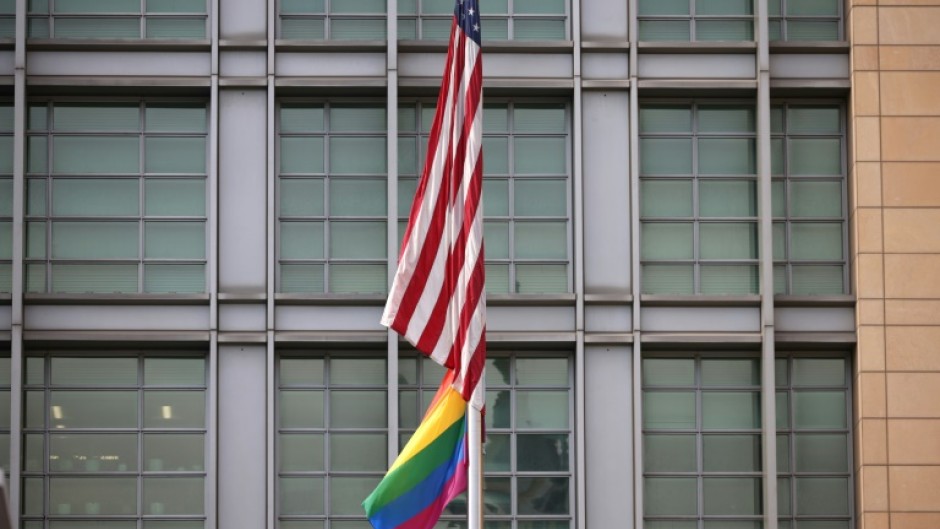 The rainbow flag flies under the US flag at the entrance to the US embassy in Moscow in June 2021