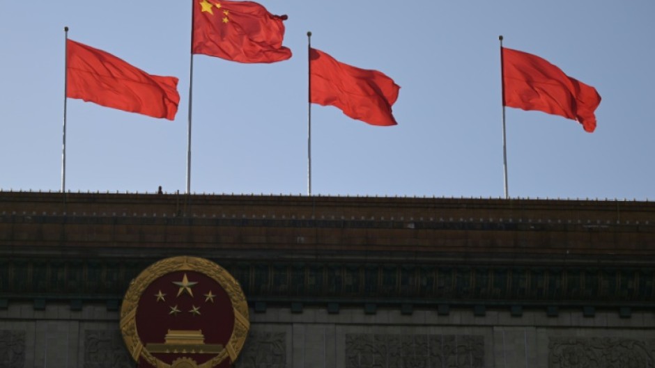 Chinese flags flutter atop the Great Hall of the People in Beijing on March 3, 2024, ahead of the country's annual legislative meetings known as the "Two Sessions".