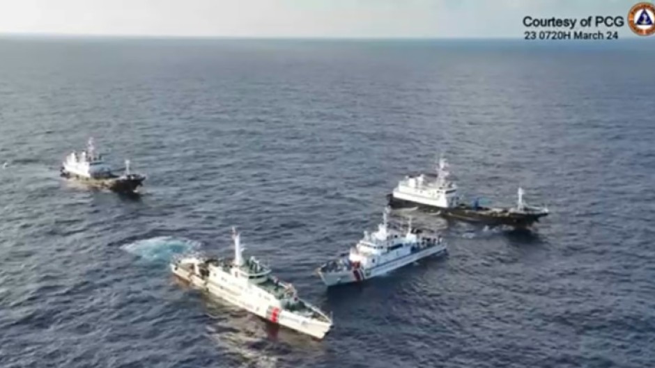 Aerial video footage shows a China Coast Guard ship (2nd L) and vessels identified by the Philippine Coast Guard as 'Chinese maritime militia' (L and R) surrounding the Philippine ship BRP Cabra