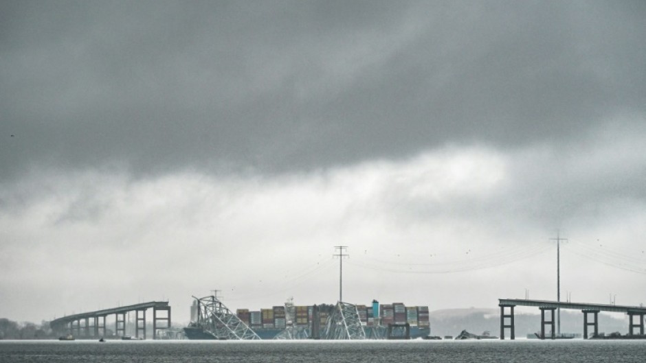 The Dali, a Singaporean-flagged cargo vessel that spans the size of almost three football fields, remains stuck under debris from the Francis Scott Key Bridge on March 27, 2024 after the ship crashed into the bridge in Baltimore, Maryland