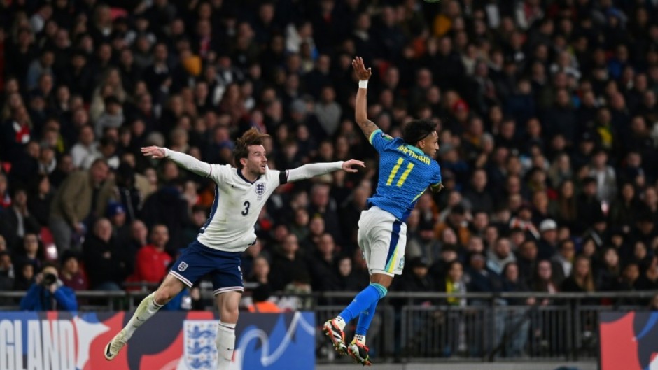England defender Ben Chilwell (L) in action against Brazil midfielder Raphinha (R) during a recent friendly international at Wembley