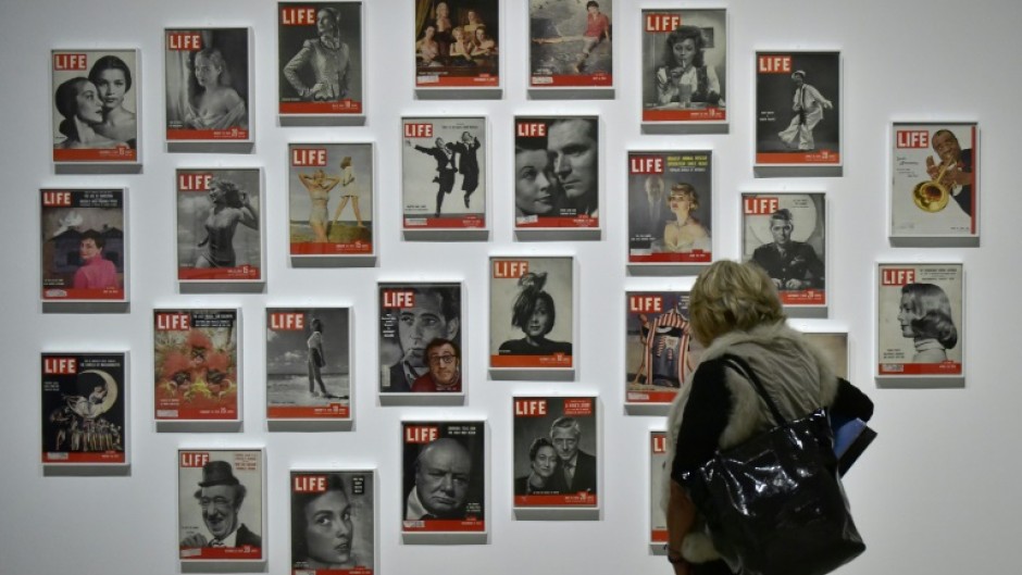 A woman looks at LIFE magazine copies as part of the show "Sorprendeme!", a retrospective of Philippe Halsman at CaixaForumin Madrid, November 30, 2016