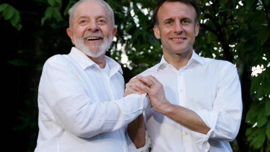 Brazilian President Luiz Inacio Lula Da Silva (L) and French President Emmanuel Macron smile together at Combu Island, Brazil, on March 26, 2024