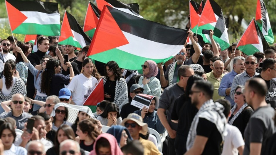 Arab citizens of Israel wave Palestinian flags as they demand an end to the Gaza war at an annual commemoration