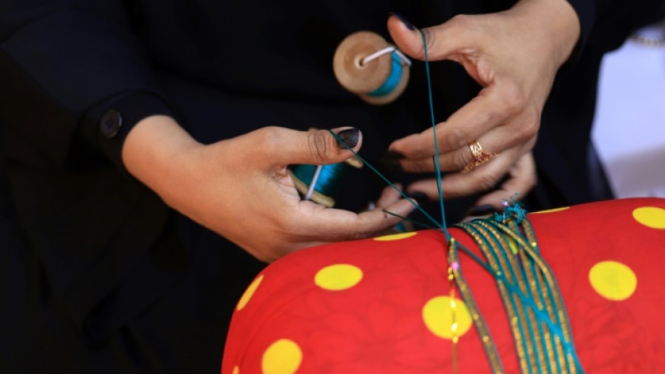 The art of hand-weaving braided shiny ribbons to adorn traditional clothing and bags is called Al Talli, and is on UNESCO's Intangible Cultural Heritage of Humanity list