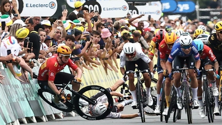 Norwegian rider Soren Waerenskjold (L) crashes during a sprint finish in the 2023 Tour de France