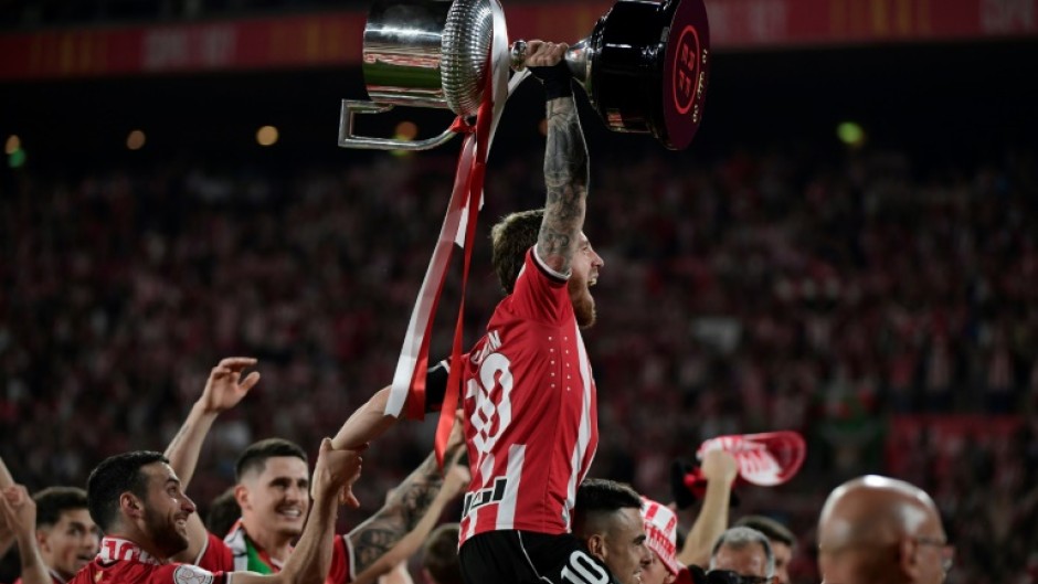 Athletic Bilbao captain Iker Muniain raises the trophy after winning the Copa del Rey against Mallorca on penalties