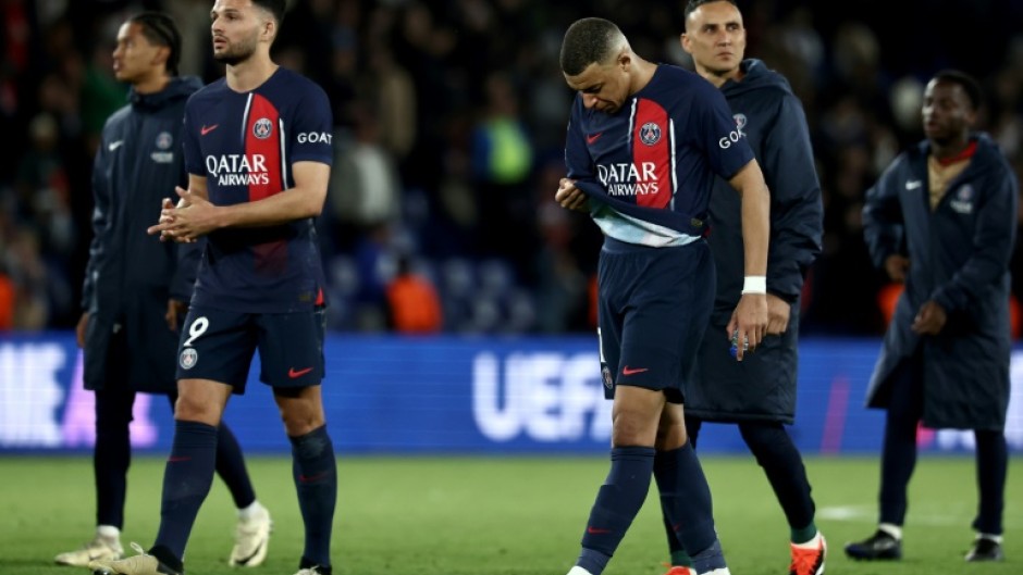 Kylian Mbappe walks off the pitch with PSG teammates after the French side's 3-2 defeat by Barcelona in the first leg of their Champions League quarter-final tie