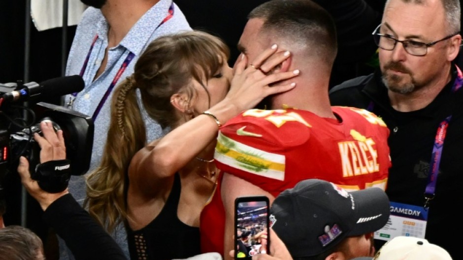 Taylor Swift, shown here kissing Travis Kelce at the 2024 Super Bowl, was spotted at Coachella similarly canoodling with her NFL boyfriend during the set of Bleachers, which is fronted by her producer
