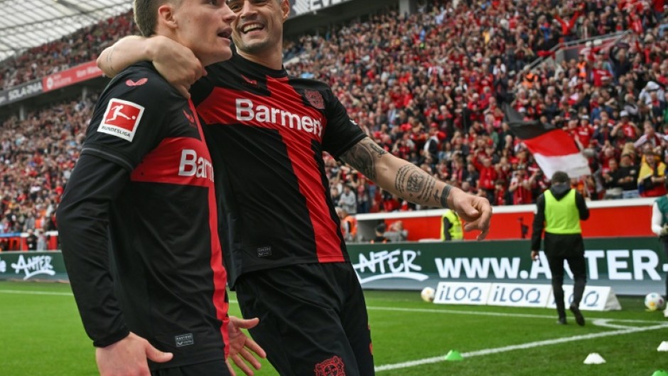Florian Wirtz (L) and Granit Xhaka (R) will be staying with new Bundesliga champions Bayer Leverkusen next season