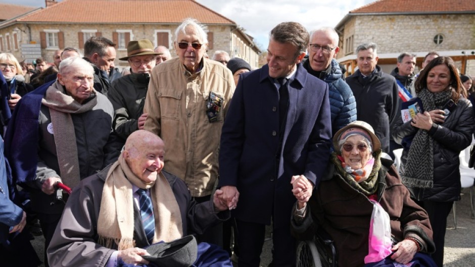 French President Emmanuel Macron meets 98-year-old former Resistance fighter Alphonse Taravello (left) and 99-year-old Yvonne Cheval (right), who lost part of her family during World War II
