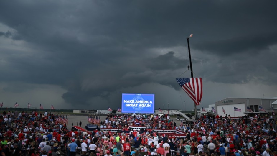 Supporters of Republican presidential candidate Donald Trump await his speech under the threat of a storm at a campaign rally in Wilmington, North Carolina, on April 20, 2024. The event was eventually called off because of weather