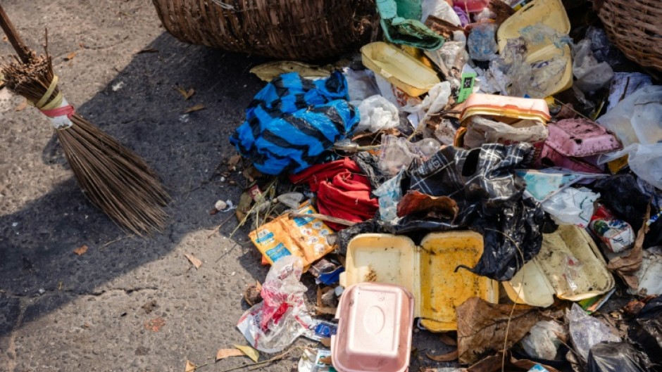 Lagos State Waste Management Authority (LAWMA) staff cleans up piled up waste from the road side at Ikoyi in Lagos on January 2024