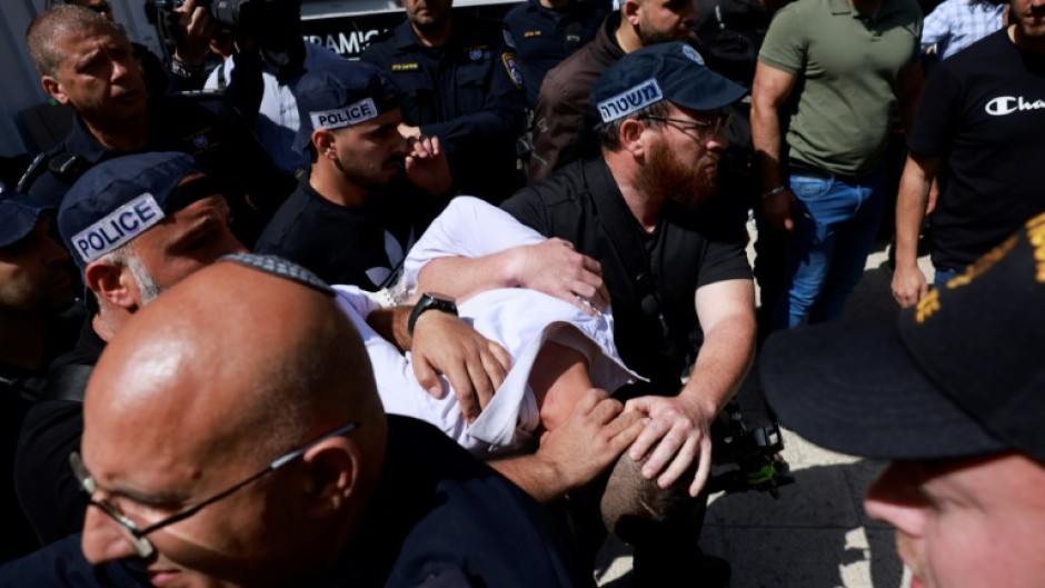 Israeli police detain a man at the site of a reported ramming attack in Jerusalem