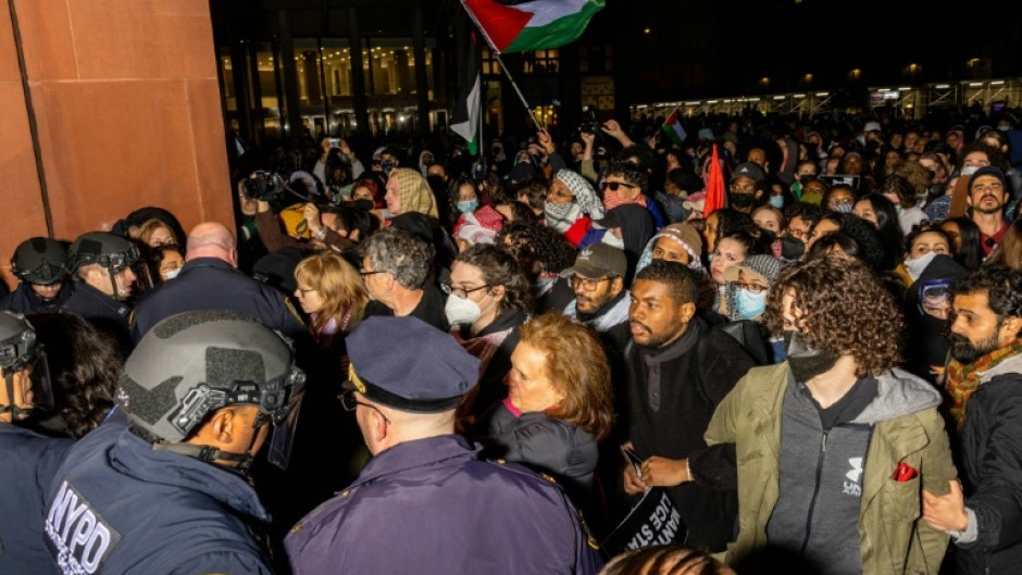 New York Police Department officers detain pro-Palestinian students and protesters who had set up an encampment on the campus of New York University to protest the Israel-Hamas war