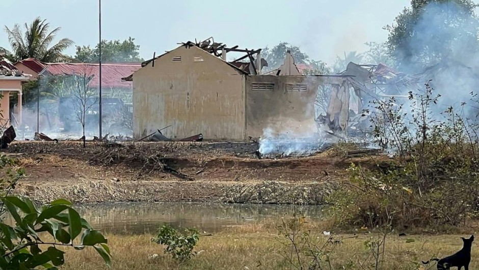 Smoke billows from a warehouse following an explosion at an army base in Cambodia