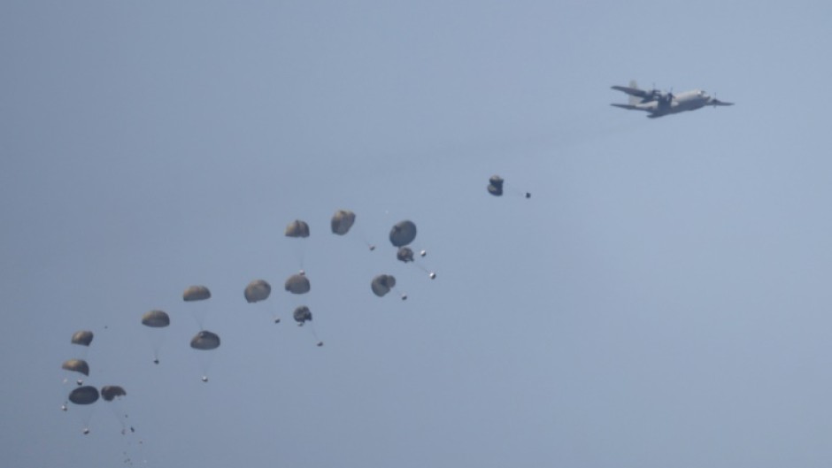 Humanitarian aid is airdropped over besieged Gaza, where the World Food Programme has warned famine is a 'real and dangerous threat'