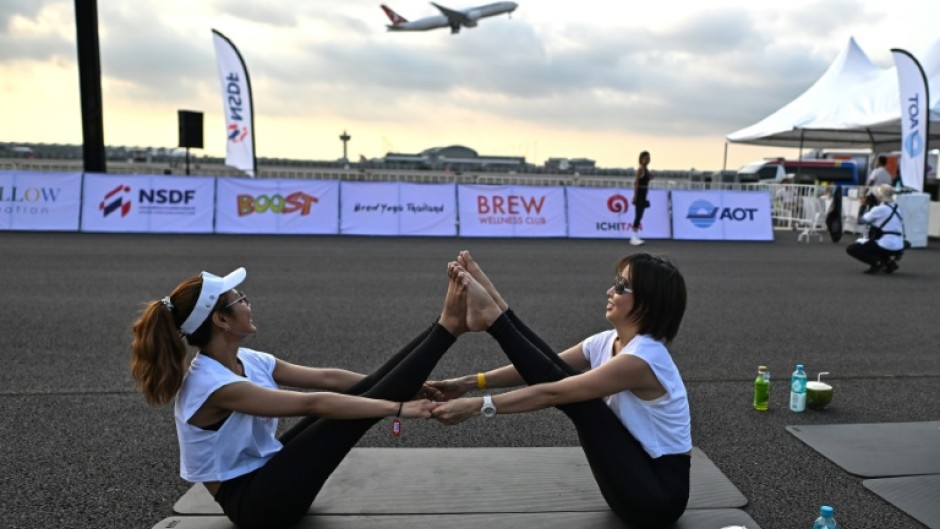 A sunrise "Brew Yoga" event on a runway at Bangkok's international airport on April 27, 2024