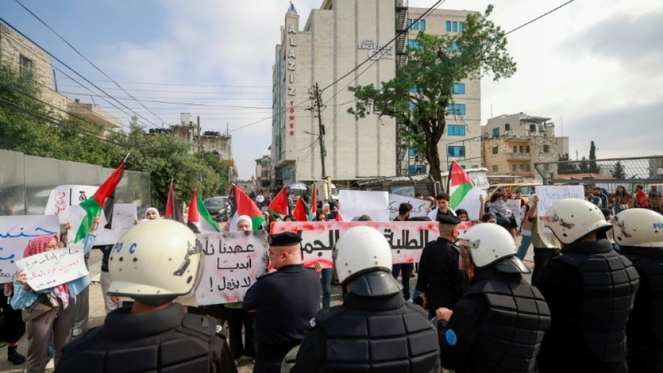 Palestinian Authority police prevent demonstrators from reaching the Canadian Representative Office in the occupied West Bank