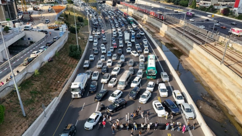 Relatives and supporters of Israeli hostages held in Gaza block Ayalon Highway in Tel Aviv, calling for their release 