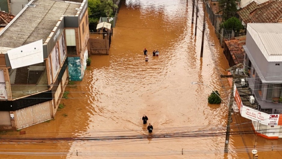Aerial view of people walking through a flooded street at the Navegantes neighborhood in Porto Alegre, Rio da Grande do State, Brazil
