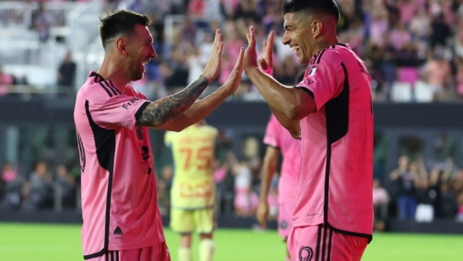 Luis Suarez celebrates with Lionel Messi after scoring his third goal against the New York Red Bulls in Saturday's 6-2 win.