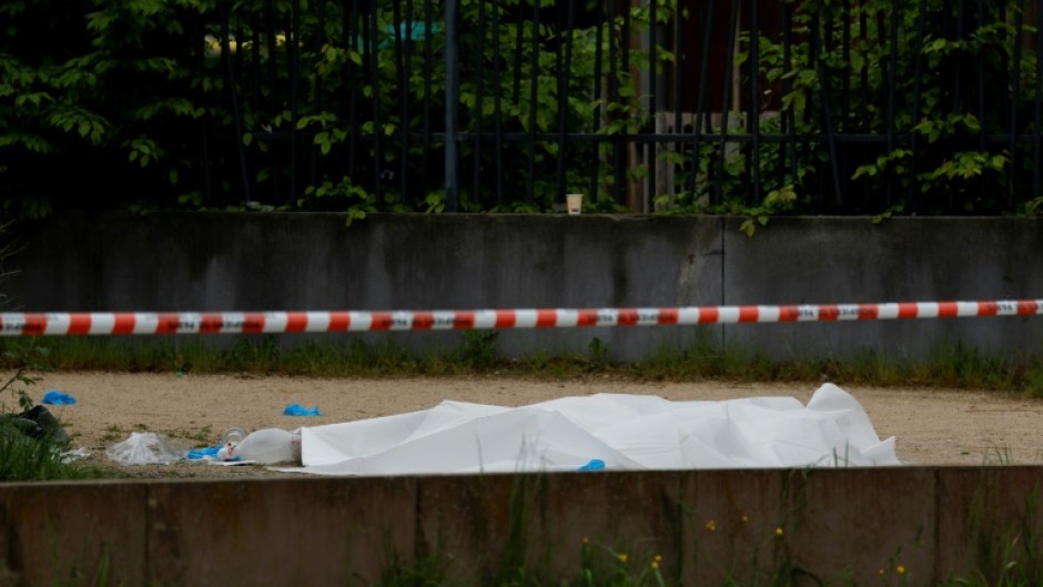 A body covered with a sheet after a double shooting in Sevran, northeast of Paris, on Sunday