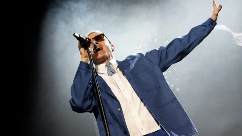 Macklemore, shown here performing in Paris in 2023, has released socially aware music in the past, supporting LGBTQ+ rights while also criticizing ills including poverty and consumerism