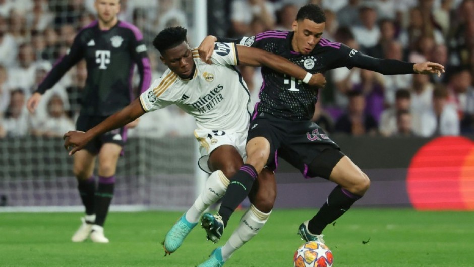 Real Madrid's French midfielder Aurelien Tchouameni (L) is not completely ruled out from returning for the final