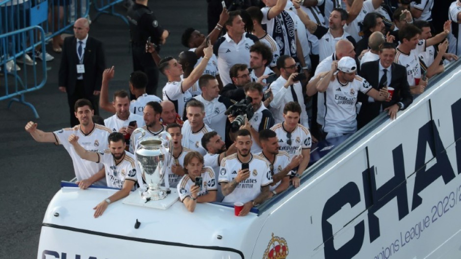 Real Madrid players parade the Champions League trophy on an open top bus after they won it for the 15th time at Wembley on Saturday