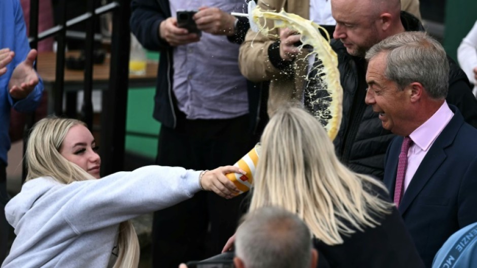 A 25-year-old woman doused Nigel Farage with a milkshake at his inaugural campaign rally